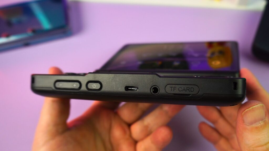 The bottom features volume power button USB headphone jack and micro SD card slot