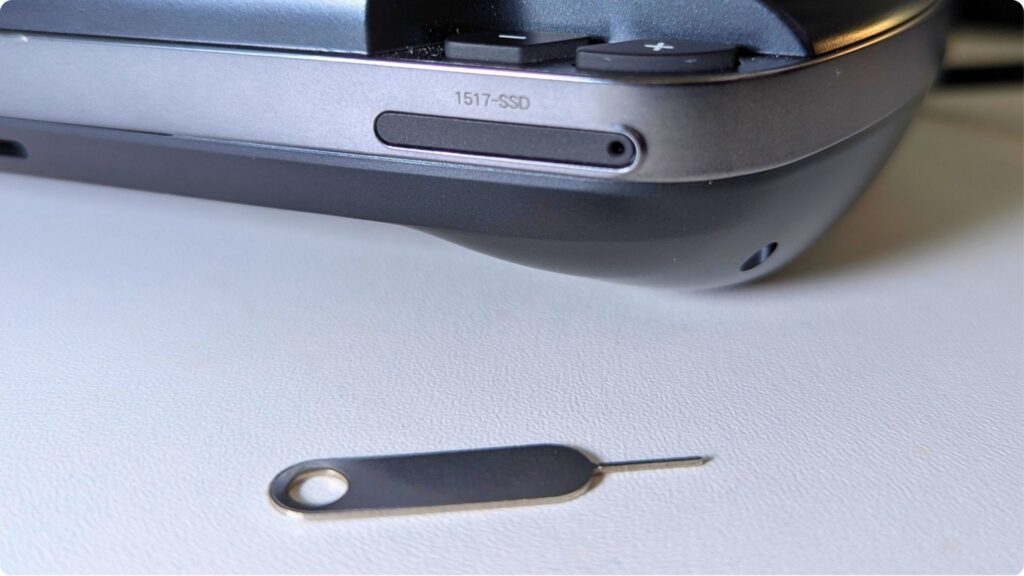 Push the SIM tool into the Mini SSD slot hole