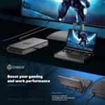 GPD WIN Mini 2024 connected to external GPU (eGPU) and large monitor. Compact clamshell device displays futuristic armored character on its 7" screen. eGPU unit enhances graphics performance. Large monitor shows expanded game view. Setup demonstrates versatility - from portable gaming to desktop-class performance. Text highlights "Boost your gaming and work performance with an eGPU". Features USB 4 ports with 40Gbps speeds, compatible with accessories and docking stations. Note: GPD G1 eGPU sold separately.