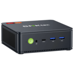 The image shows the GMKTEC NUBOX M5 Mini PC, a sleek and compact computing device. It has a modern design with a matte black finish. The front panel features several connectivity ports, including USB ports and an audio jack, and the GMKTEC logo is prominently displayed on the top. The overall design is minimalist, emphasizing portability and functionality for diverse computing tasks.
