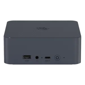 The front view of a compact Beelink EQI12 Mini PC in dark grey. It features a USB-A port, a 3.5mm headphone jack, a USB-C port, and a power button. The casing has a textured design on the top with a circular logo.
