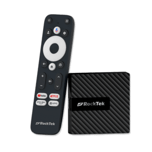 RockTek GB1 Android TV box shown alongside its dedicated remote control. The compact device has a sleek, textured design. The remote features a circular navigation pad, voice control button, and dedicated buttons for popular streaming services like YouTube, Netflix, and Prime Video, along with an 'Apps' button for quick access to installed applications