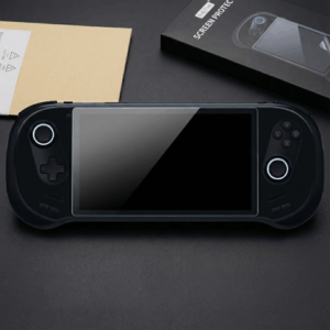 A black AYANEO 3 handheld gaming console lies centered on a dark surface, featuring a newly applied tempered glass screen protector. The console's dual joysticks are illuminated with circular white LED rings. To the top right, the product packaging is visible, showing a black box labeled "METIK SCREEN PROTECTOR" with an illustrative diagram of the installation process. The sleek, matte black finish of the device and the glossy reflection on the protected screen create a high-end, tech-focused aesthetic.