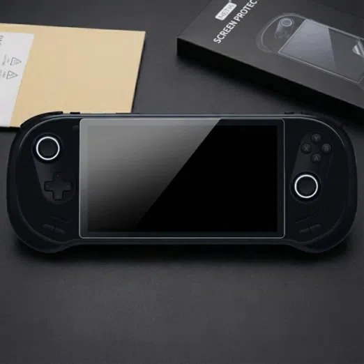 A black AYANEO 3 handheld gaming console lies centered on a dark surface featuring a newly applied tempered glass screen protector The consoles dual joysticks are illuminated with circular white LED rings To the top right the product packaging is visible showing a black box labeled METIK SCREEN PROTECTOR with an illustrative diagram of the installation process The sleek matte black finish of the device and the glossy reflection on the protected screen create a high end tech focused aesthetic