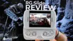 A first person perspective image showing a pair of hands holding a white RG Slide handheld gaming console centered in the frame The consoles screen displays an action packed video game with multiple characters In the background a large monitor or screen shows a blurred image of a video game character adding depth to the scene Prominently overlaid in white text at the top are the words RG Slide REVIEW A black and white DROIX logo is visible in the bottom left corner