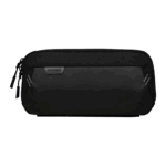 A horizontal black carrying case for a handheld gaming device is shown against a plain grey background The case has a textured top half and a smooth matte bottom half A small dark grey patch with AYANEO in white text is stitched onto the front The case has two zippers and two diagonal reflective stripes on either side of the front panel