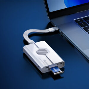 Close-up of the Biwin Mini SSD Reader connected to a laptop via a short USB-C cable, demonstrating a small form-factor Biwin SSD card being inserted into the reader's slot.