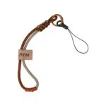 A durable paracord wrist lanyard featuring a dual tone brown and tan braided design It includes a small tan leather tag embossed with the AYN logo a decorative snake knot at the top and a bronze colored carabiner attached to a thin black loop for securing handheld devices