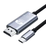 A studio photograph displays a metallic silver colored Type C to HD adapter cable against a black background The main body of the adapter features text in English 4K UHD Type C to HD Cable Model TH001 Rev No01 Made in China alongside CE WEEE and FCC symbols Connected to this metallic body are an HDMI male connector on one end and a black insulated cable on the opposite end Additionally a separate Type C male connector with its matching silver housing is shown below the main body also with its cable partially visible All connections feature black heat shrink or plastic where the cables meet the connectors