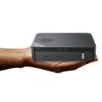 GPD Box Mini PC being held in a hand to show the ultra-compact scale and 0.9L chassis design of the Panther Lake AI computer.
