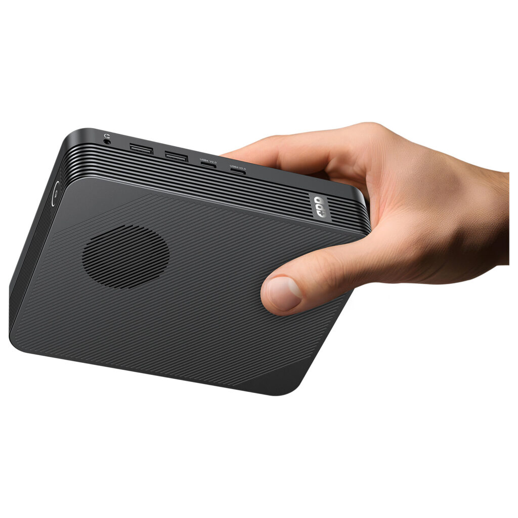 GPD BOX 4 A person's hand holds the matte black GPD unit horizontally against a white background, highlighting its small, handheld form factor. The side profile clearly shows the headphone jack, dual USB-A ports, and dual USB4 V2.0 ports.