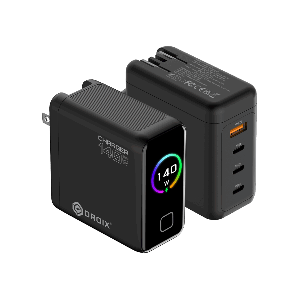 DROIX140WBLACKDONE01 DROIX Global A detailed product render of two DROIX 140W GaN Wall Chargers from different perspectives displayed on a black background The foreground charger is in a front three quarter view It is a matte black block with its US foldable plug partially extended on the left side On its side prominent white text reads CHARGER 140W with a large O and a small 140 above the O and the DROIX logo below it The front glossy black face features a central circular display with a dynamic rainbow colored ring around the white text 140 W and a small green charging icon Below the display is a button or LED indicator The background charger is in a rear three quarter view showing the ports and text details It lists extensive multi line technical specifications and safety certifications in small white text such as model numbers voltagecurrent ratings and CE FCC UKCA marks This unit displays its four output ports from top to bottom one orange accented USB A port labeled with small text 225W Max followed by three USB C ports labeled in order 40W 100W and 140W Both units show top ventilation grills This composition provides a comprehensive view of the charger's branding, display, and port capabilities.