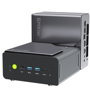 A product shot showing two identical compact mini PCs on a solid black background. One unit sits horizontally in the foreground, displaying its front panel with a glowing green power button, three USB-A ports, a Type-C port, and a headphone jack. The second unit is placed vertically directly behind it, showcasing its sleek gray side panel with the "GMKtec" logo and a view of the rear I/O connectivity ports.