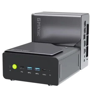 A product shot showing two identical compact mini PCs on a solid black background. One unit sits horizontally in the foreground, displaying its front panel with a glowing green power button, three USB-A ports, a Type-C port, and a headphone jack. The second unit is placed vertically directly behind it, showcasing its sleek gray side panel with the "GMKtec" logo and a view of the rear I/O connectivity ports.